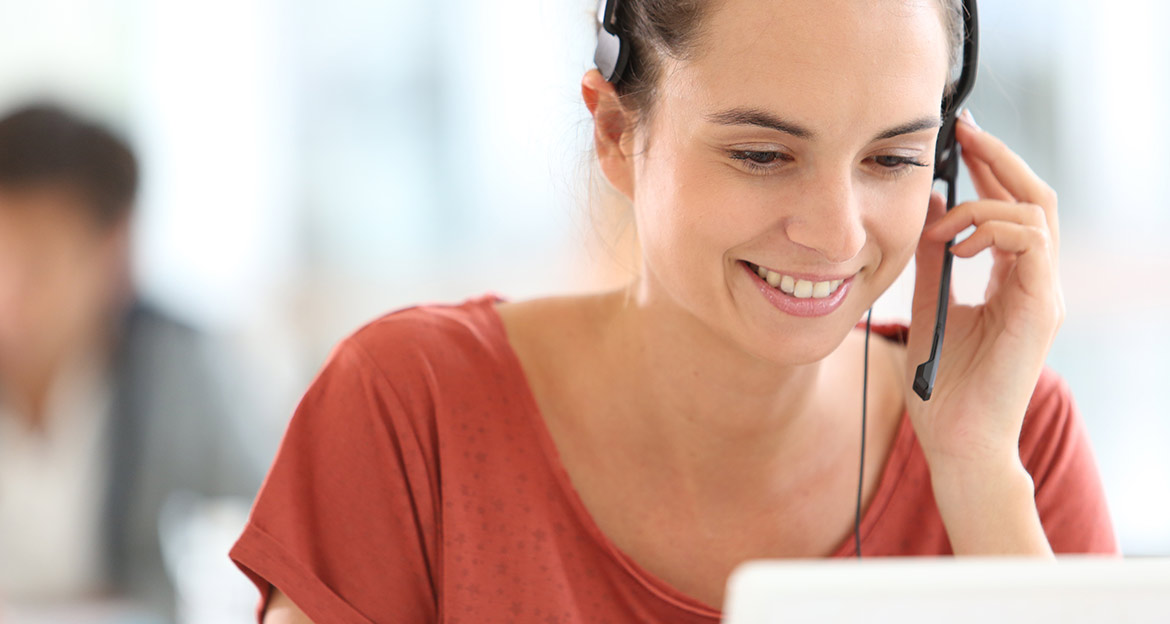 Woman in red with headset providing customer service