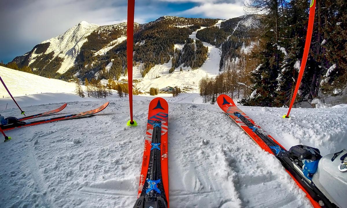 Skiing equipment at top of hill in front of mountain